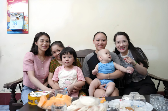 Chị Nga (bế bé trai) cùng gia đình chụp ảnh kỷ niệm bên bác sĩ Thùy Dương (ngoài cùng bên phải).